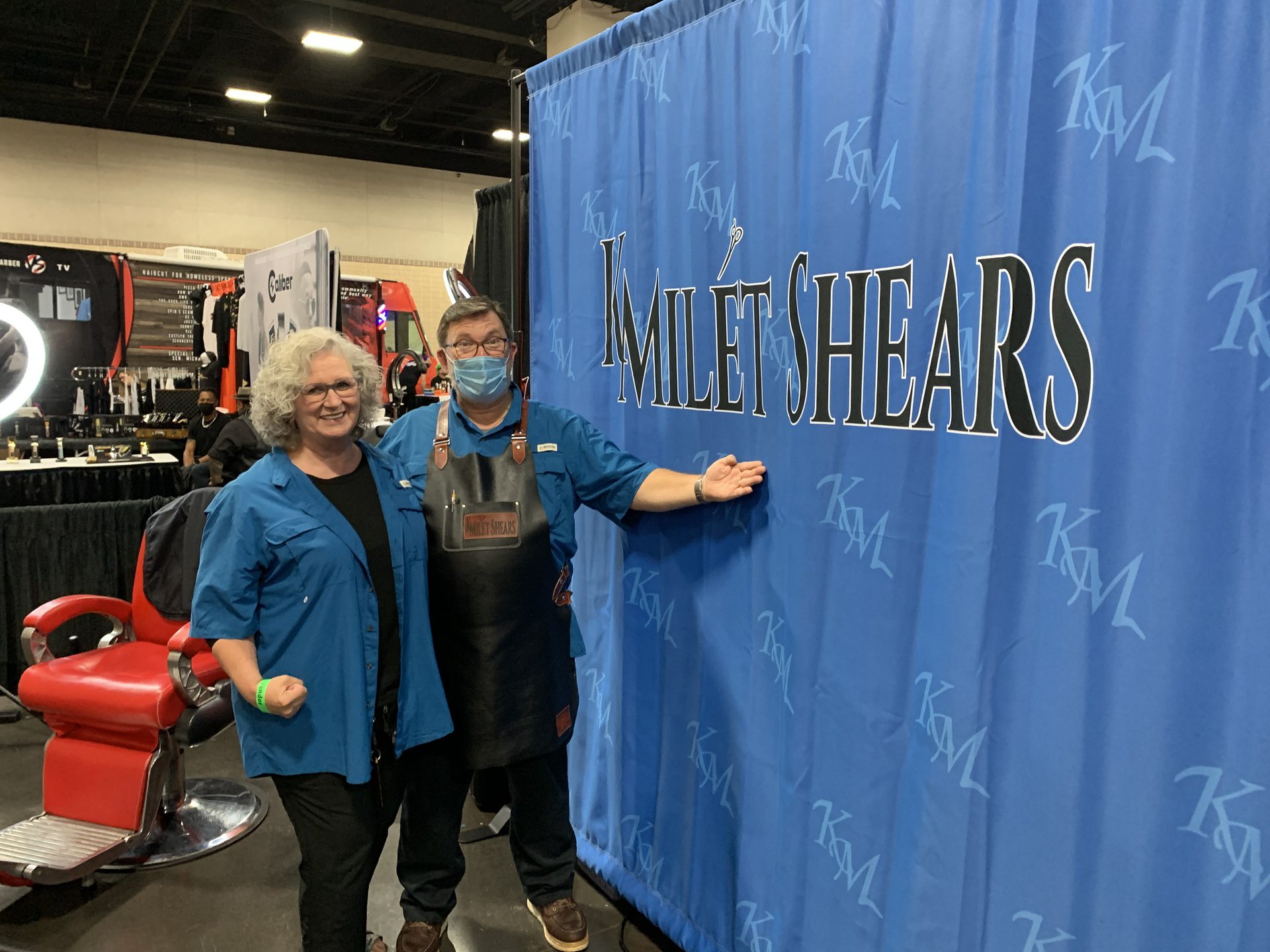 Owners in front of their company banner